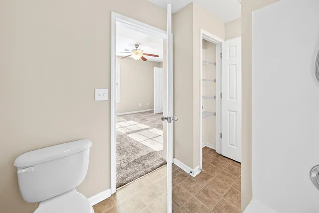 a bathroom with a toilet and a shower