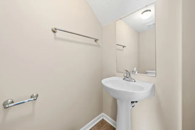 a bathroom with a sink a mirror and vanity