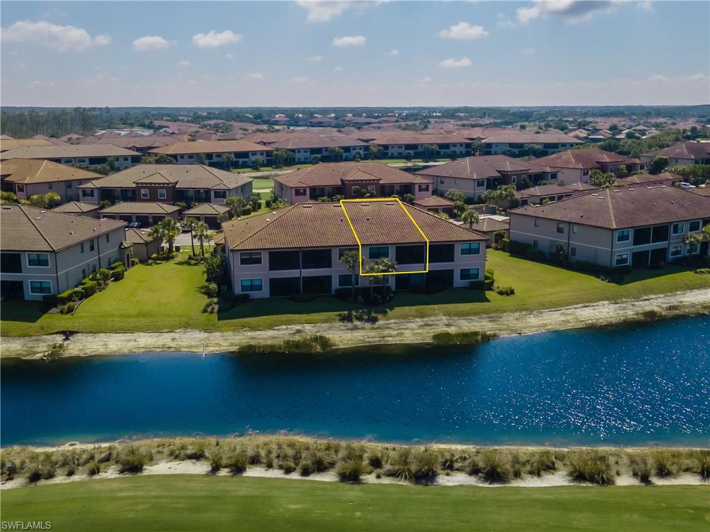 9389 Pocida Court, Unit 202 Naples, FL 34119 - Photo 20 of 38 Aerial perspective of suburban area with a nearby body of water and property boundaries highlighted