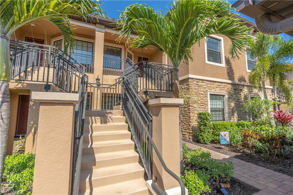 9389 Pocida Court, Unit 202 Naples, FL 34119 - Photo 2 of 38 View of exterior entry with stucco siding and stone siding