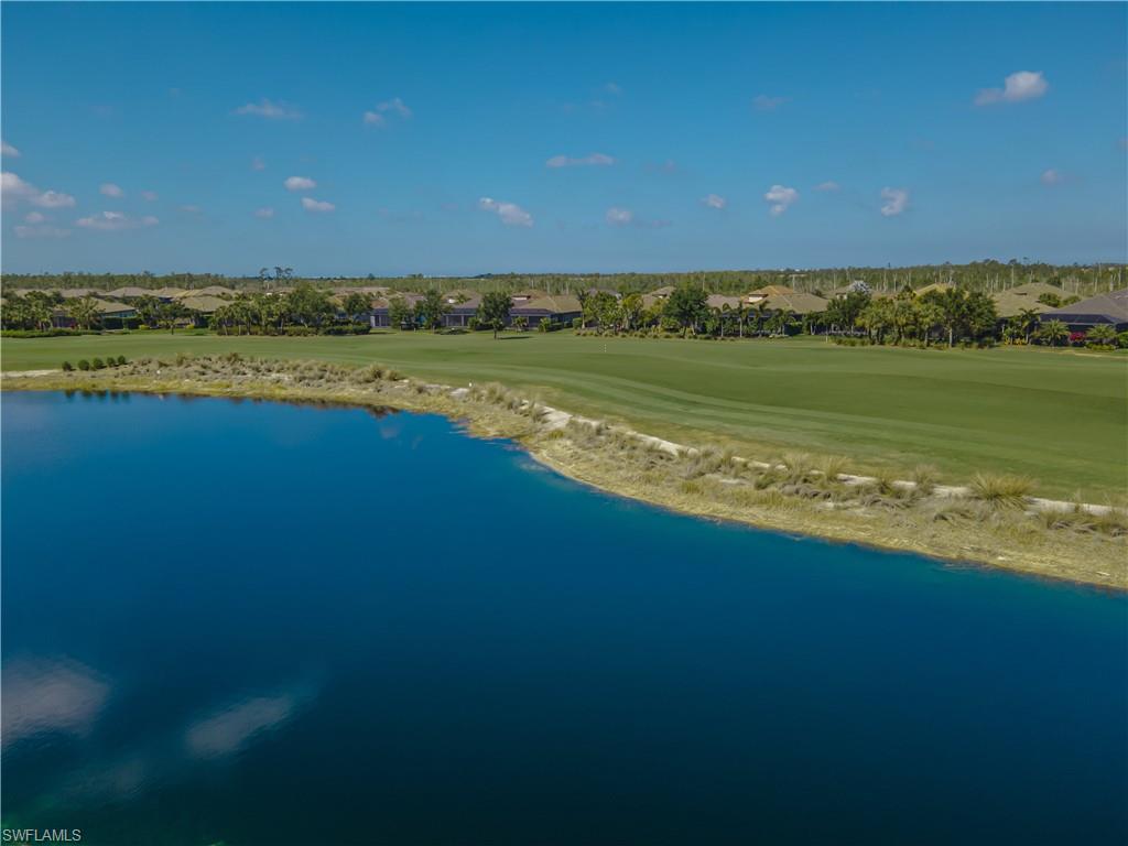 9389 Pocida Court, Unit 202 Naples, FL 34119 - Photo 24 of 38 Aerial perspective of suburban area with a golf club and a nearby body of water