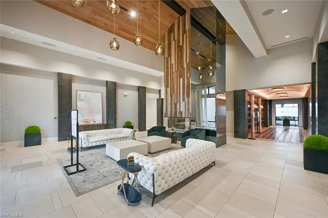 a living room with furniture and large windows