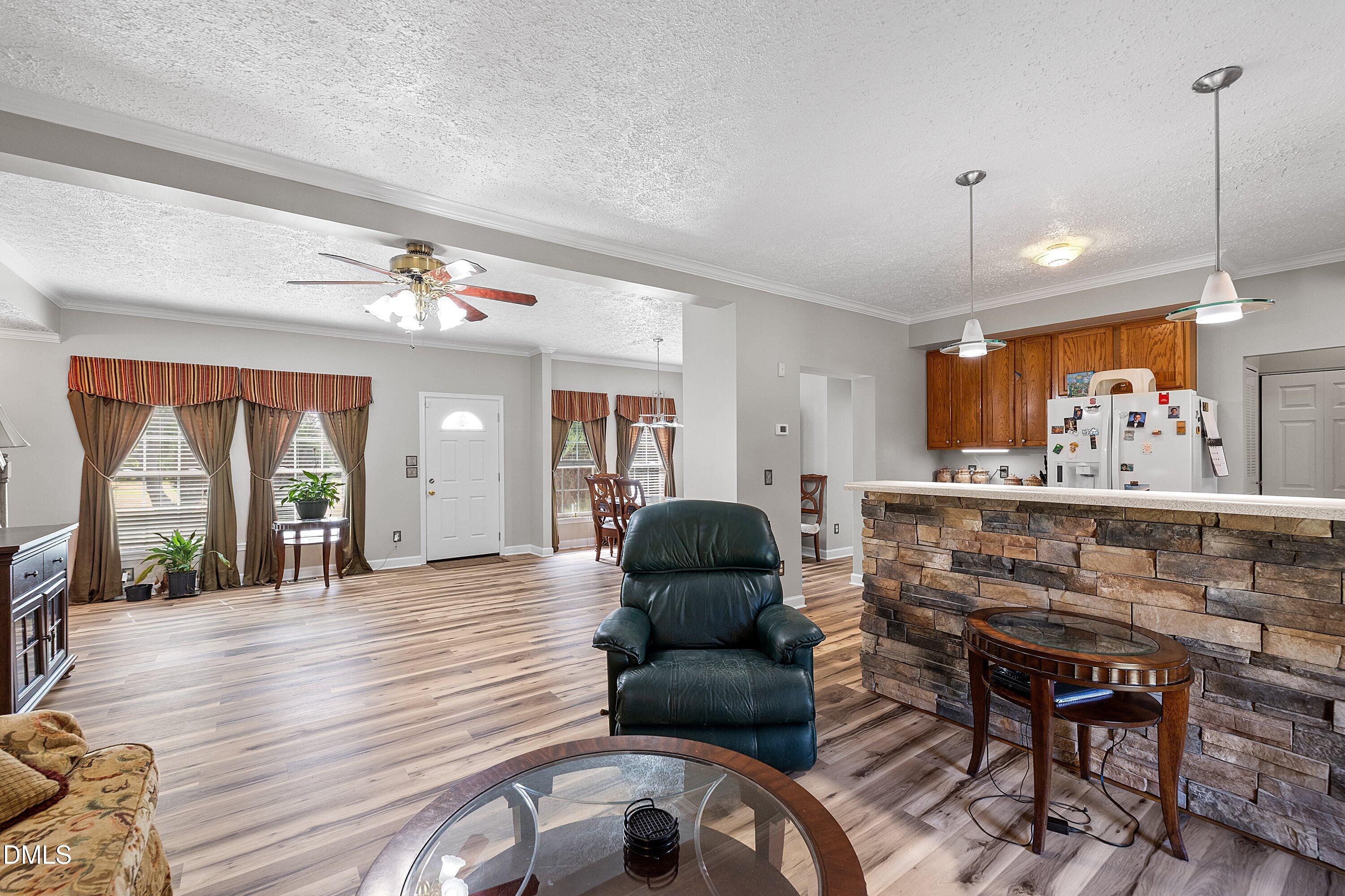 2265 Bud Lipscomb Road Willow Spring, NC 27592 - Photo 14 of 76 a living room with furniture and a large window