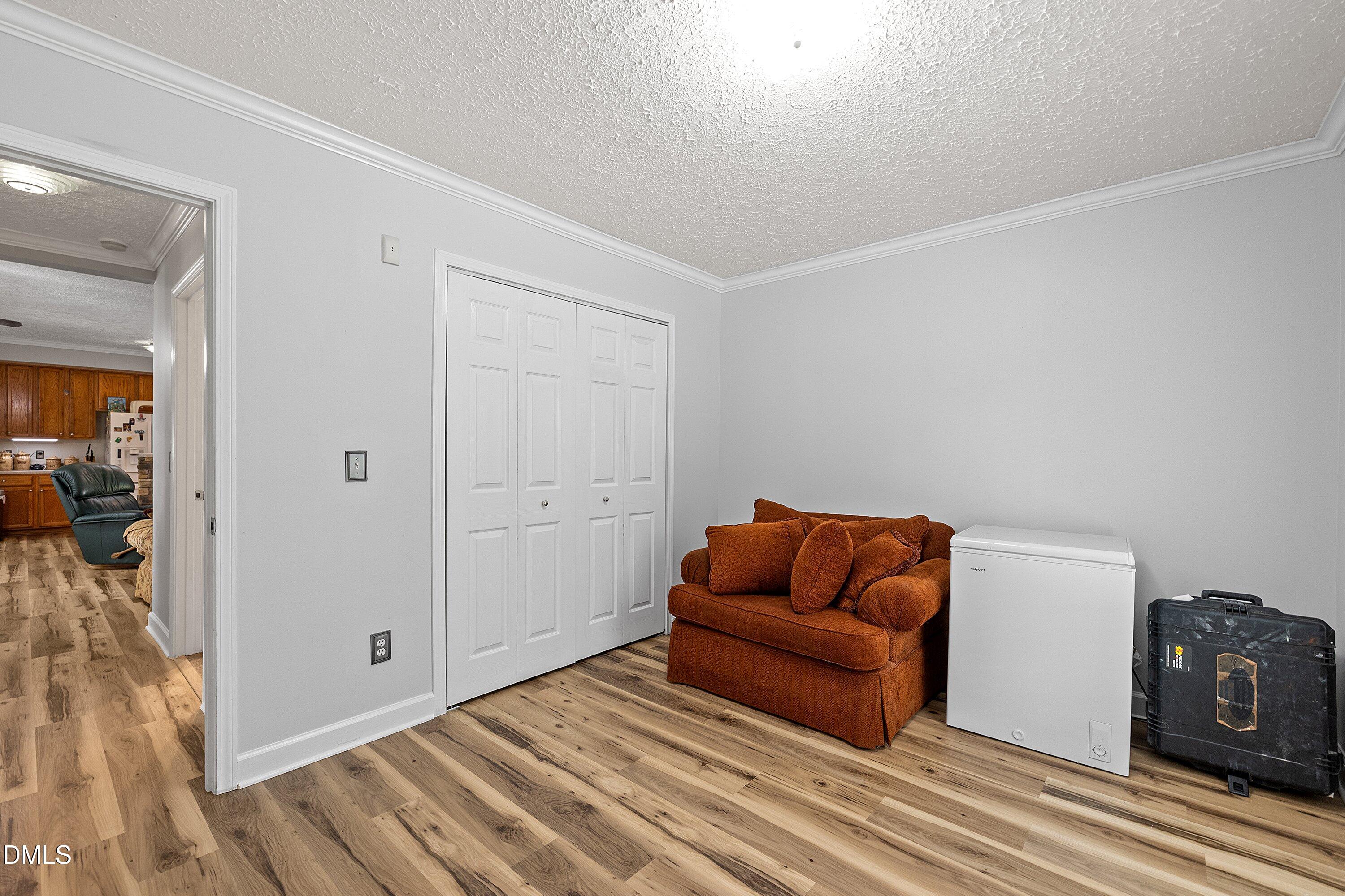 2265 Bud Lipscomb Road Willow Spring, NC 27592 - Photo 33 of 76 a living room with furniture and a wooden floor