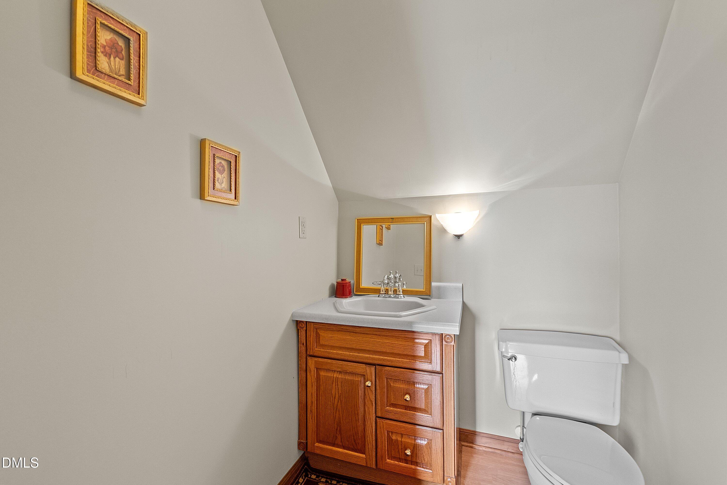 2265 Bud Lipscomb Road Willow Spring, NC 27592 - Photo 41 of 76 a bathroom with a toilet sink and mirror
