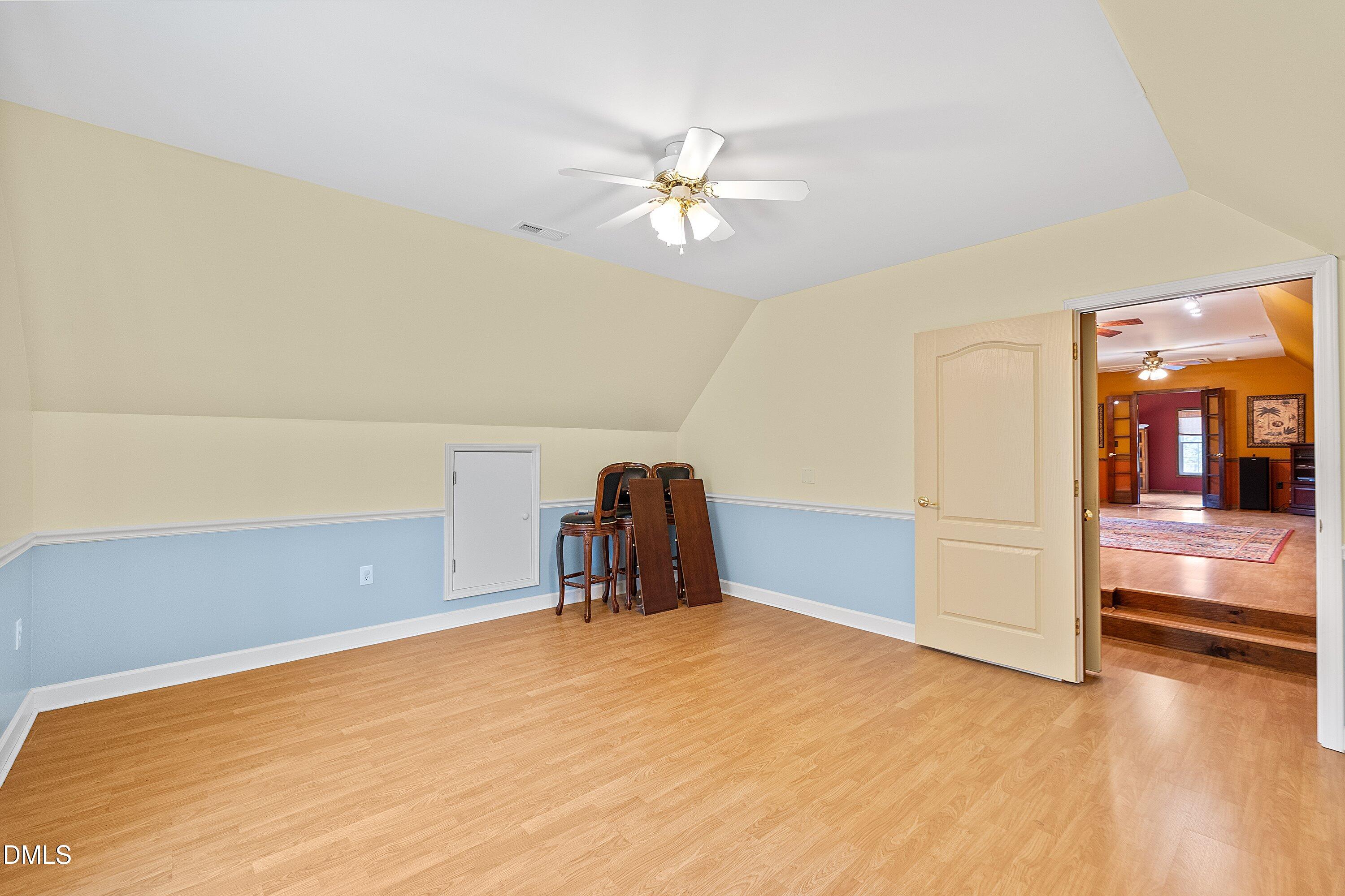 2265 Bud Lipscomb Road Willow Spring, NC 27592 - Photo 43 of 76 a view of a room with a ceiling fan and hardwood floor
