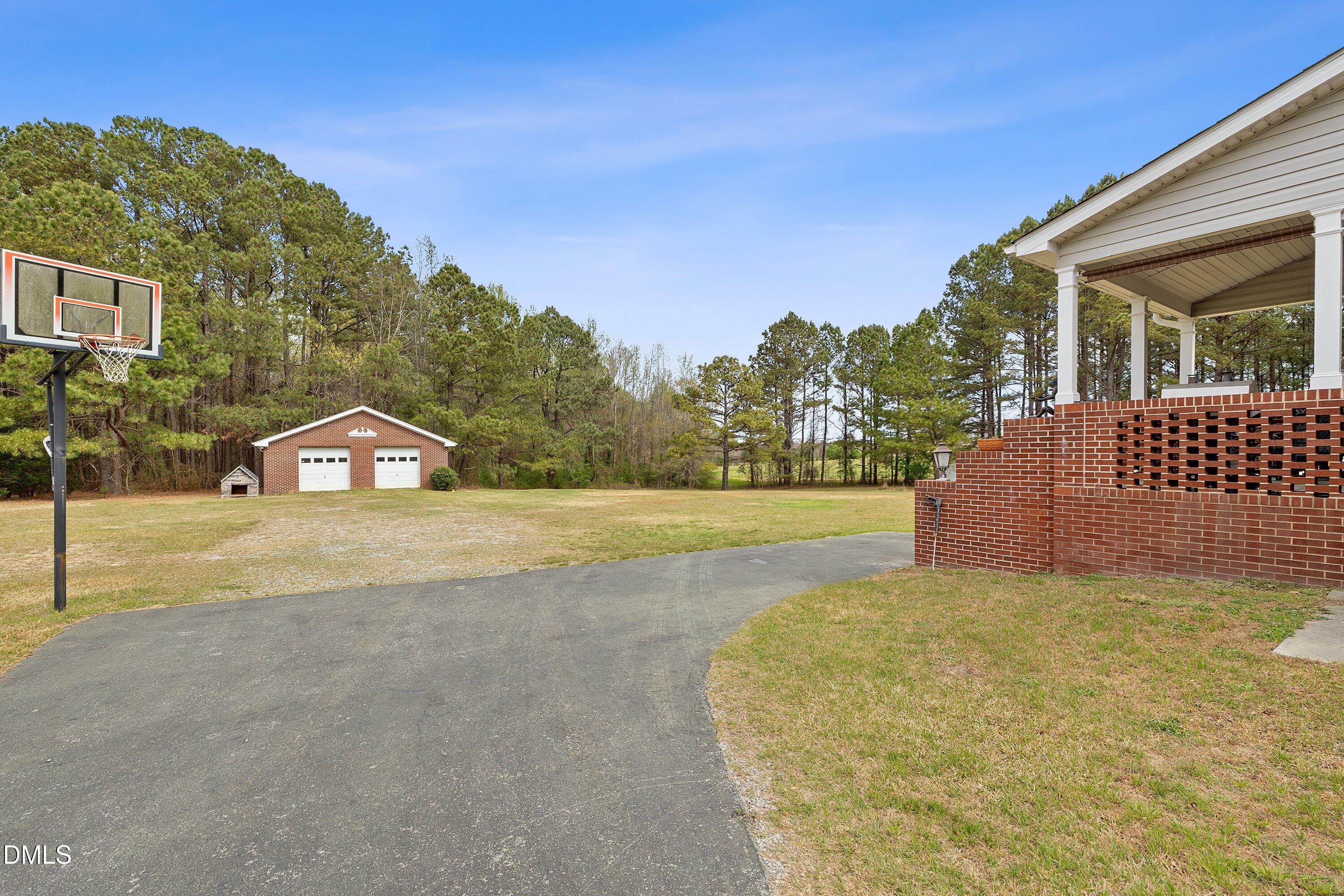2265 Bud Lipscomb Road Willow Spring, NC 27592 - Photo 45 of 76 a view of a house with a yard