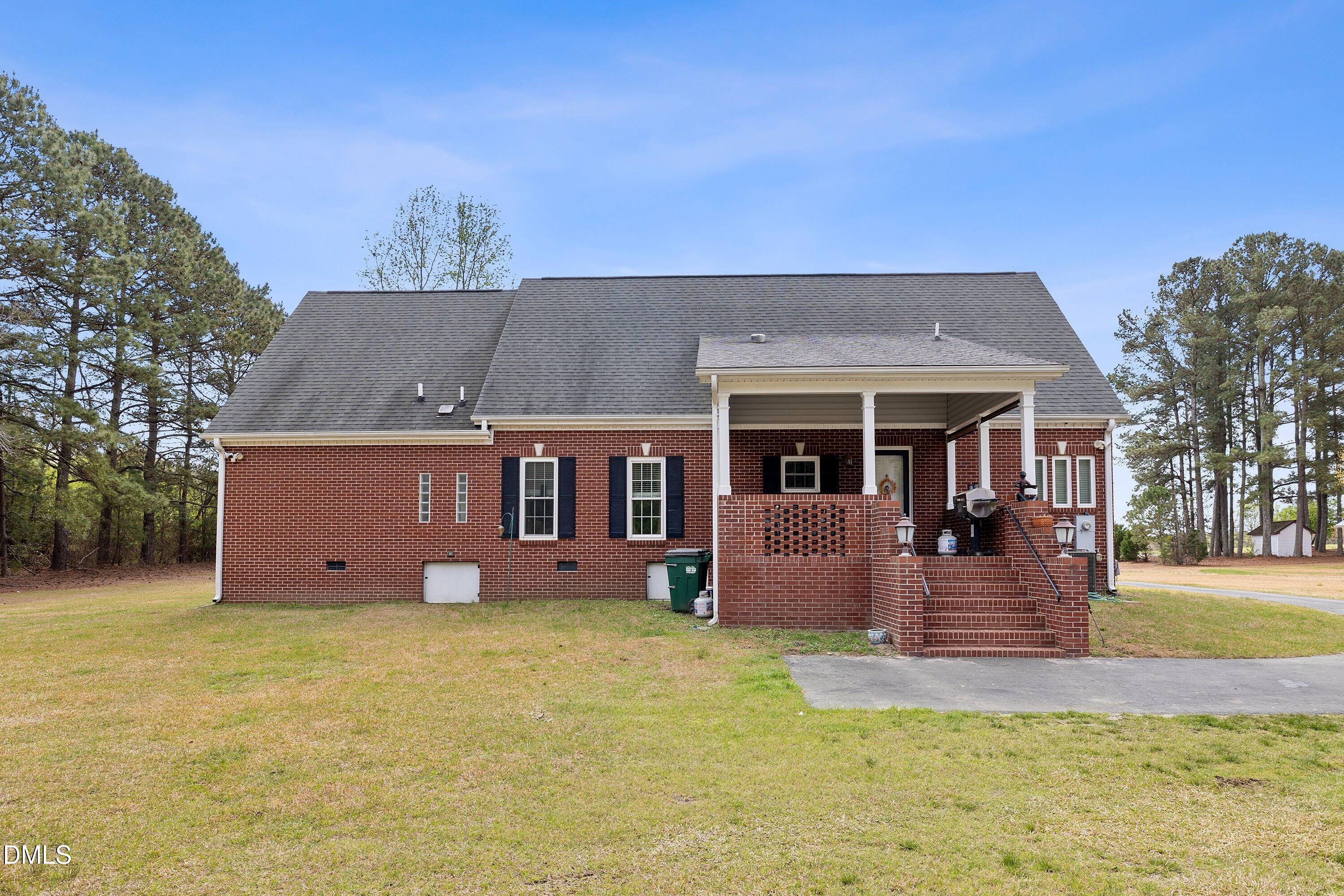 2265 Bud Lipscomb Road Willow Spring, NC 27592 - Photo 48 of 76 front view of a house with a yard