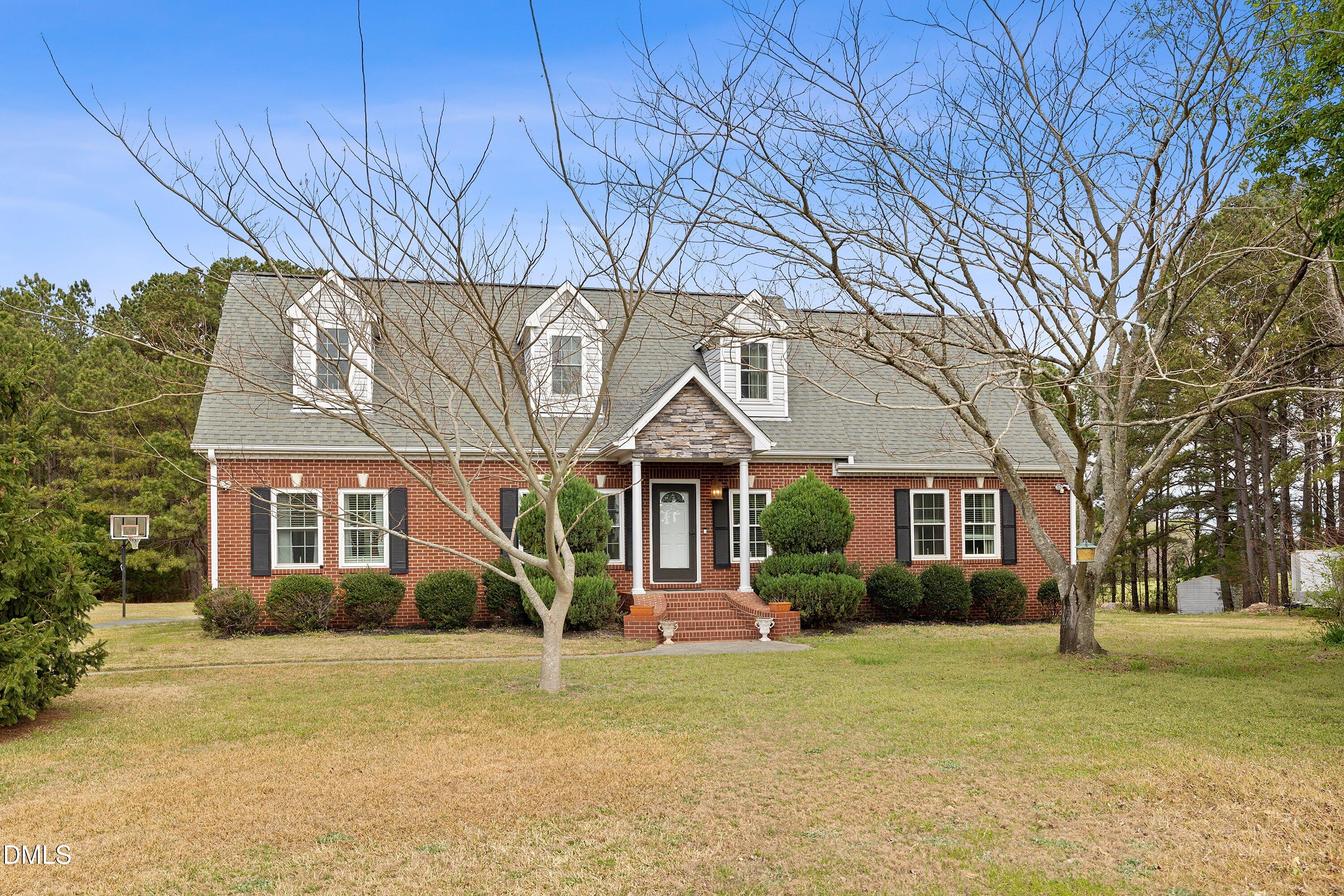 2265 Bud Lipscomb Road Willow Spring, NC 27592 - Photo 59 of 76 front view of a house with a big yard