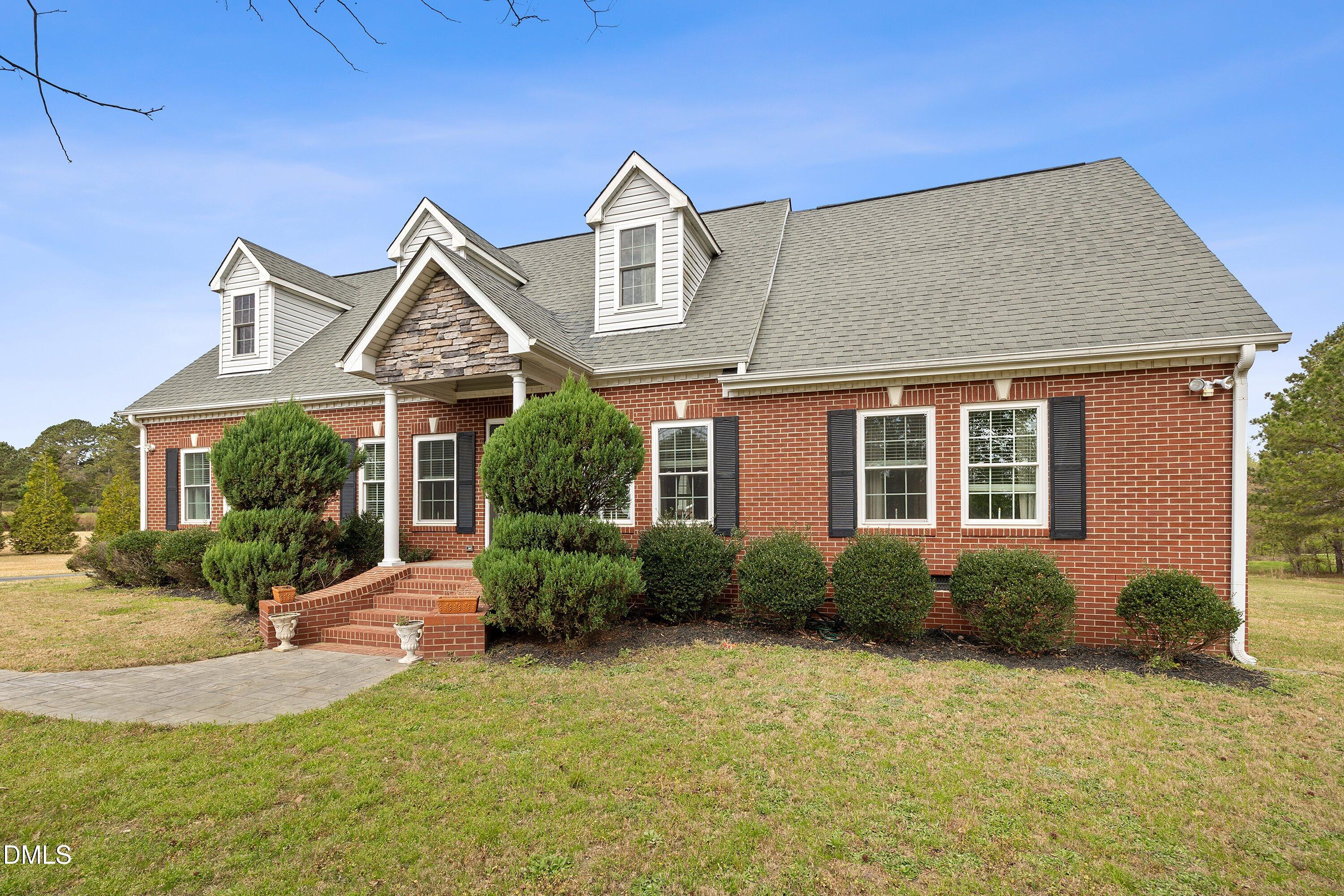 2265 Bud Lipscomb Road Willow Spring, NC 27592 - Photo 60 of 76 front view of a house with a yard