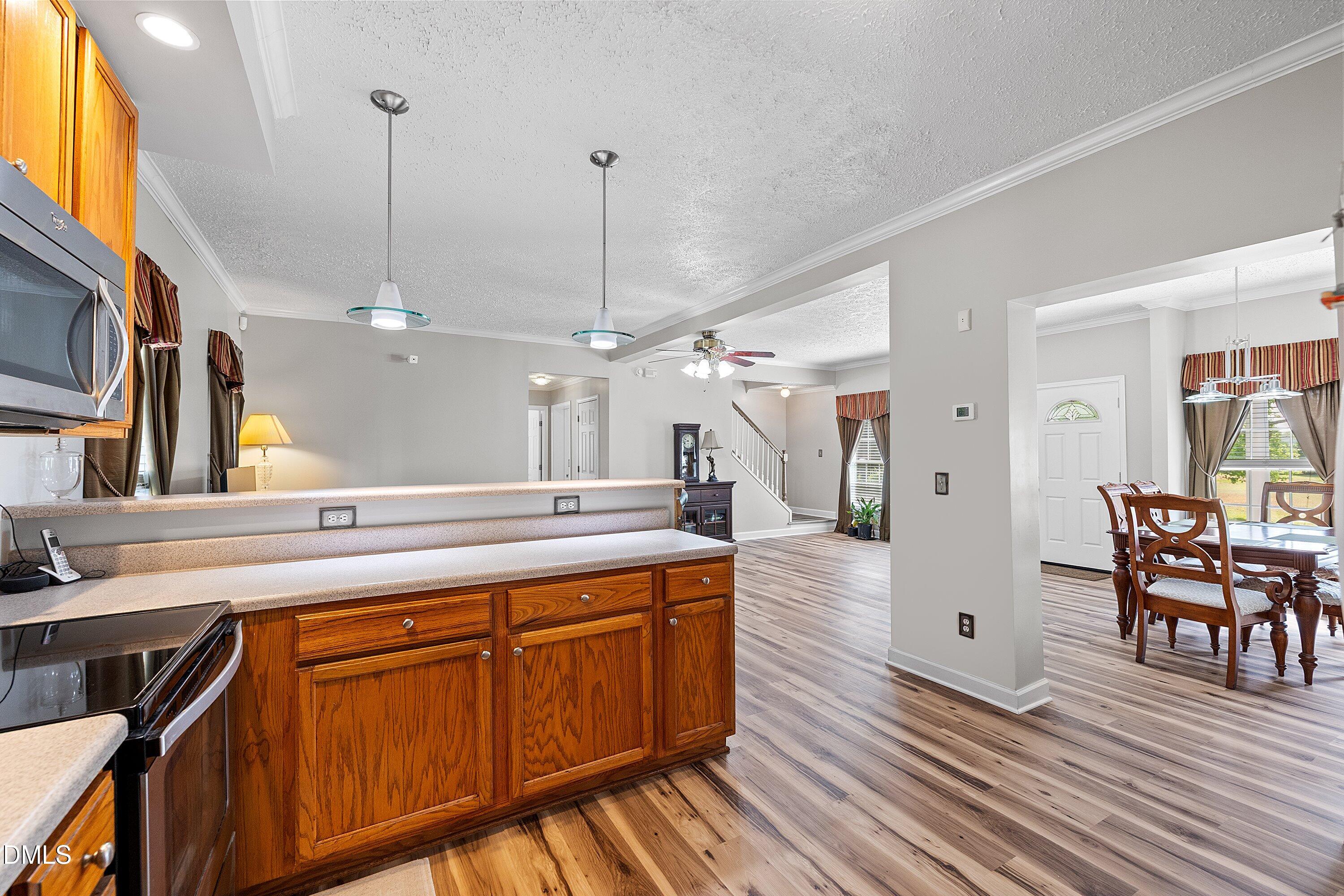 2265 Bud Lipscomb Road Willow Spring, NC 27592 - Photo 6 of 76 a kitchen with stainless steel appliances granite countertop wooden floors and sink