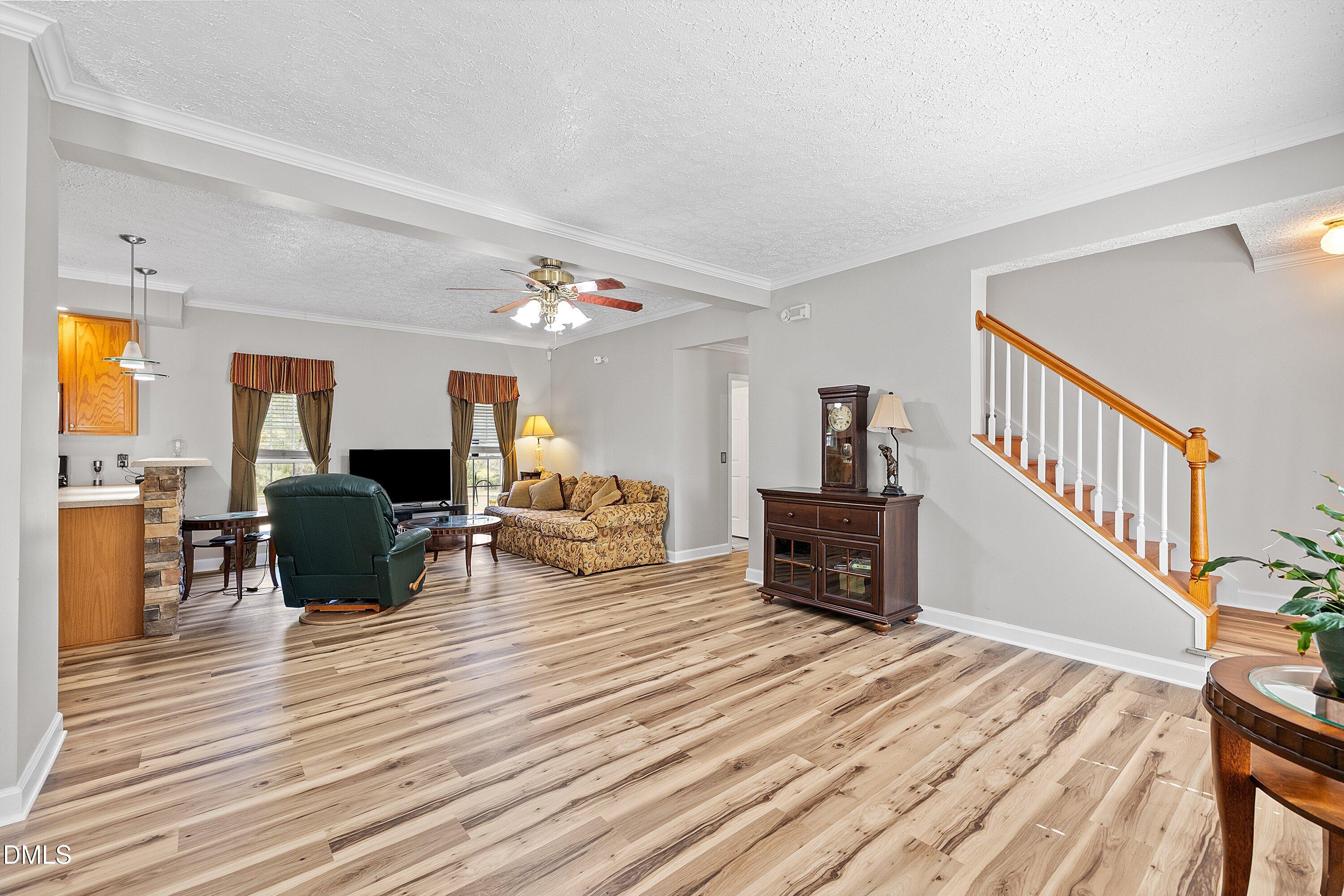 2265 Bud Lipscomb Road Willow Spring, NC 27592 - Photo 9 of 76 a living room with furniture and a wooden floor