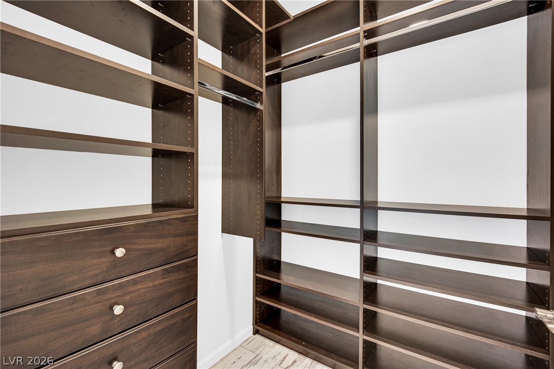 8725 West Flamingo Road, Unit 110 Las Vegas, NV 89147 - Photo 2 of 30 Custom built-in shelving and drawers provide ample storage in this well-appointed closet.