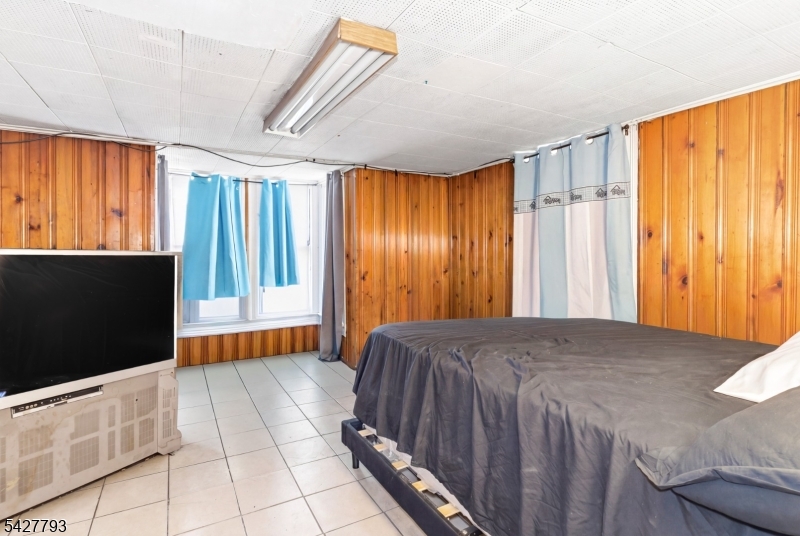 420 Mechanic Street Orange, NJ 07050 - Photo 11 of 18 a bedroom with a bed and a dresser