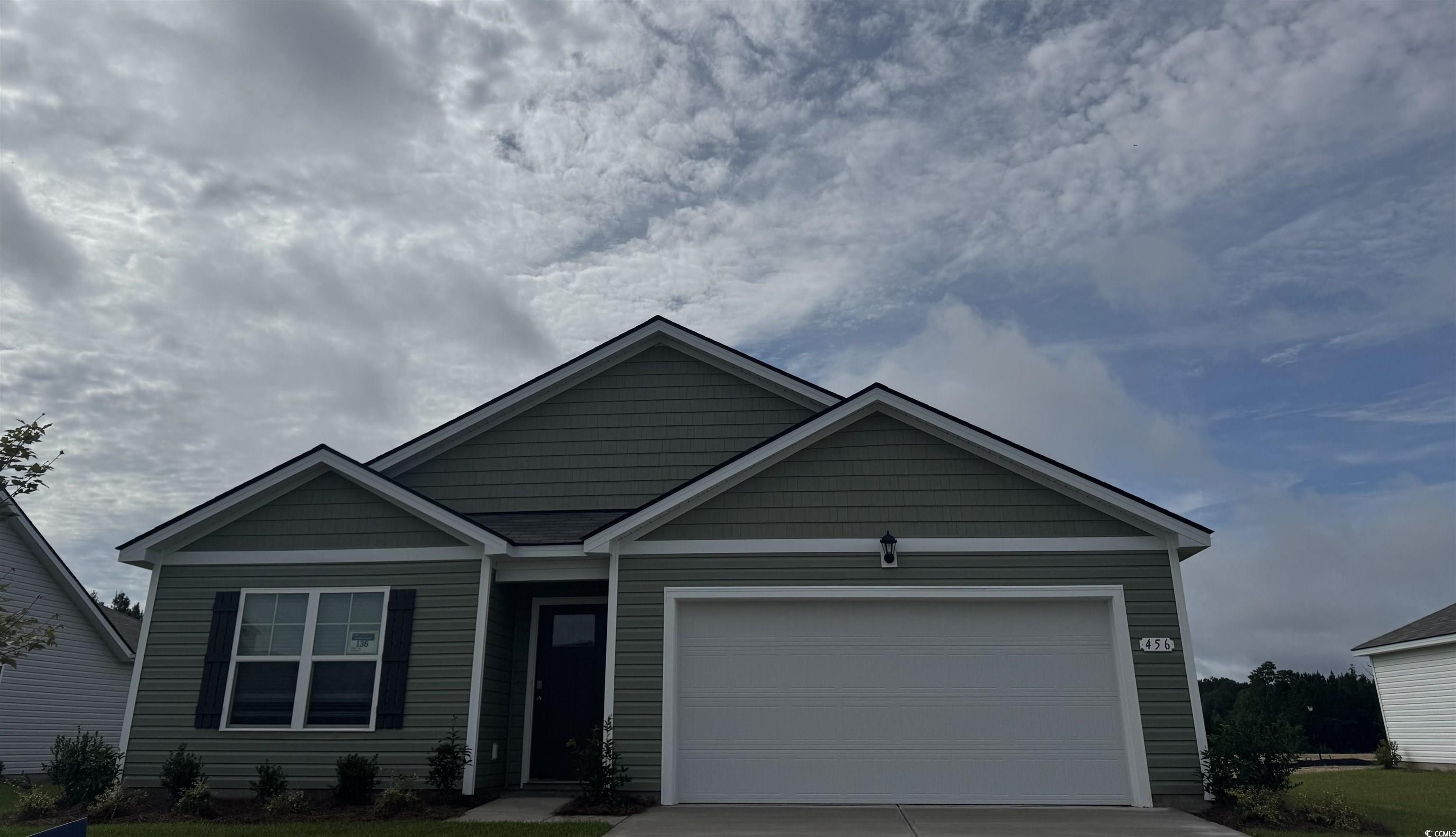 View of front of house with driveway and an attached garage
