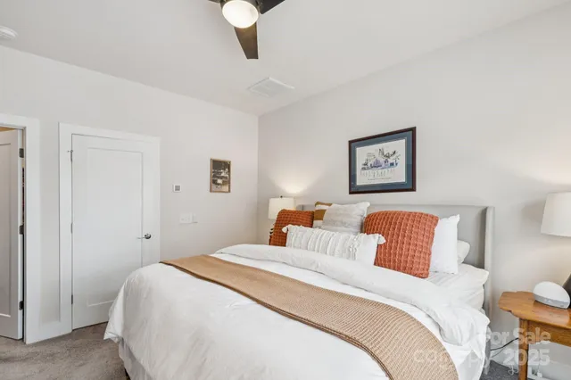 a bedroom with bed and a night stand