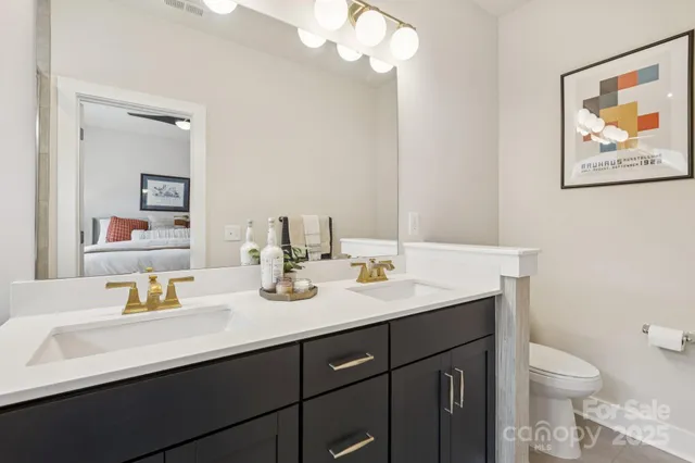 a bathroom with a sink a toilet and a mirror