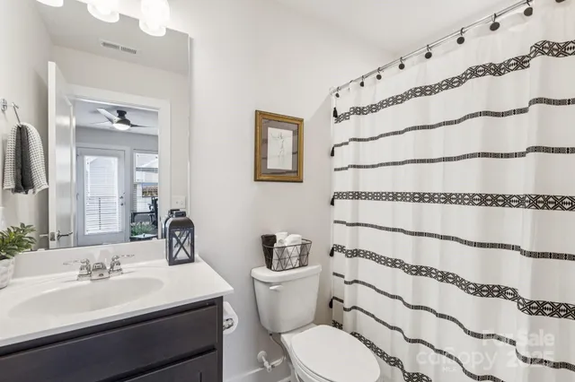 a view of a chair and table in backyard front of house