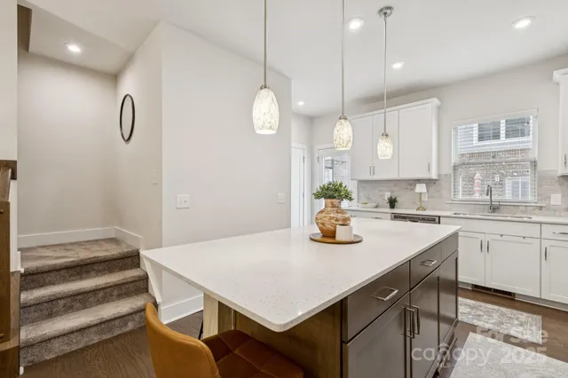 a kitchen with cabinets and window