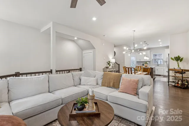 a living room with furniture and kitchen view