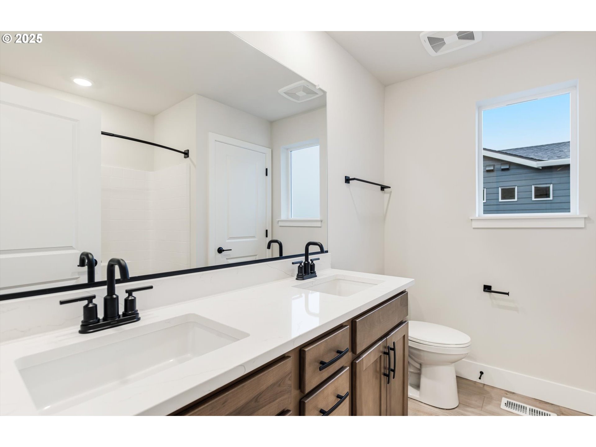8710 South 3rd Street Ridgefield, WA 98642 - Photo 19 of 22 a bathroom with a sink a toilet and a mirror