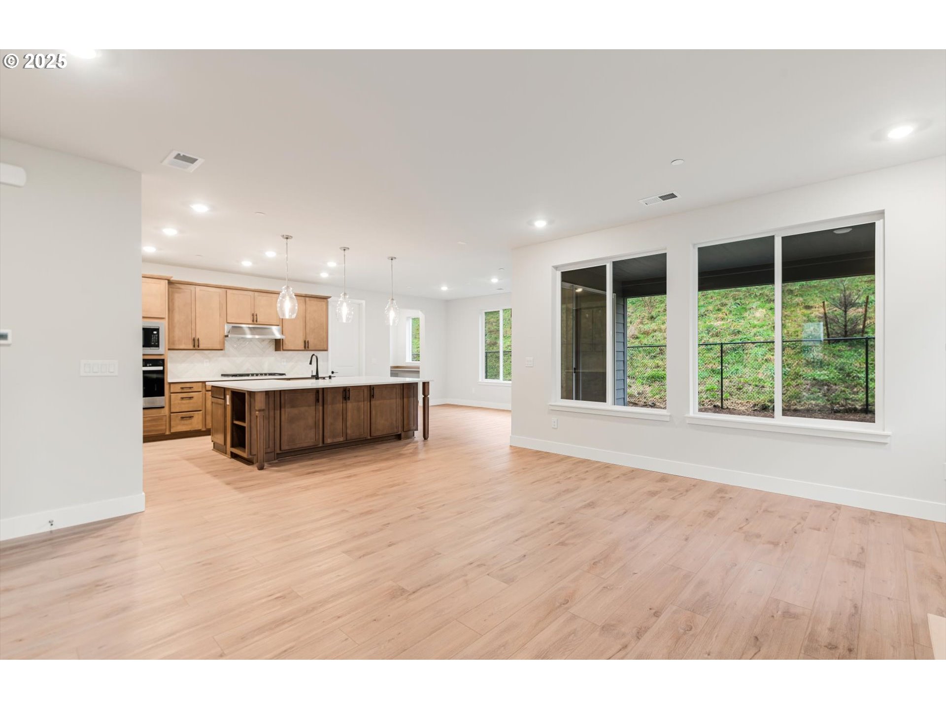 8710 South 3rd Street Ridgefield, WA 98642 - Photo 3 of 22 a view of kitchen with kitchen island a sink wooden floor and view living room