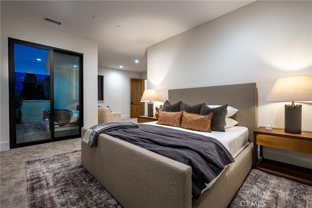 9348 Nine Bark Road Truckee, CA 96161 - Photo 14 of 58 a spacious bedroom with a bed and a walk in closet