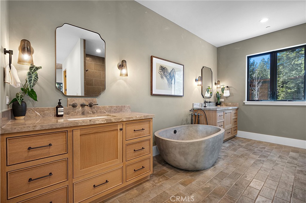 9348 Nine Bark Road Truckee, CA 96161 - Photo 15 of 58 a bathroom with a bathtub sink mirror and window