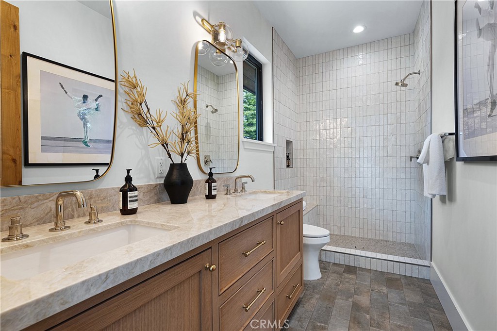 9348 Nine Bark Road Truckee, CA 96161 - Photo 21 of 58 a bathroom with a double vanity sink toilet and shower