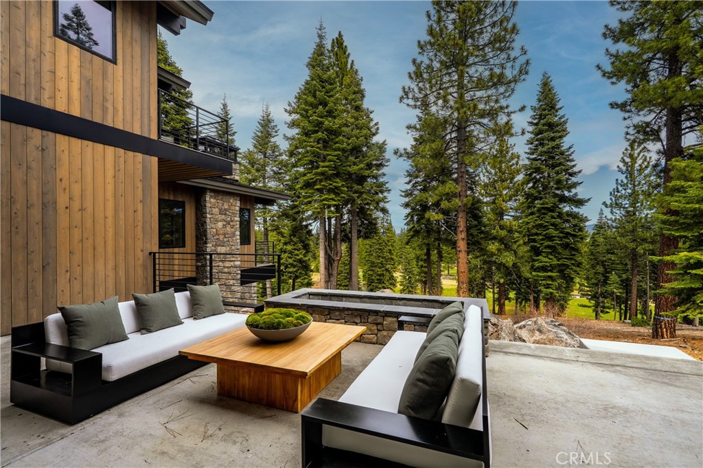 9348 Nine Bark Road Truckee, CA 96161 - Photo 23 of 58 a view of a patio with couches and a fire pit next to a yard