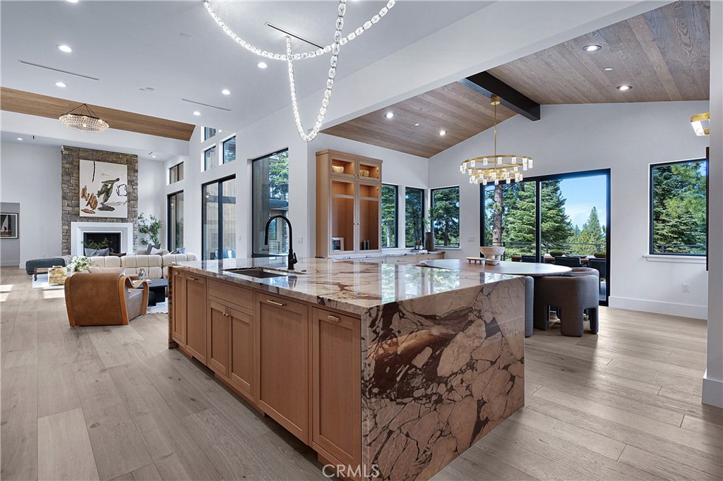9348 Nine Bark Road Truckee, CA 96161 - Photo 26 of 58 a large living room with stainless steel appliances kitchen island granite countertop wooden floor and large window