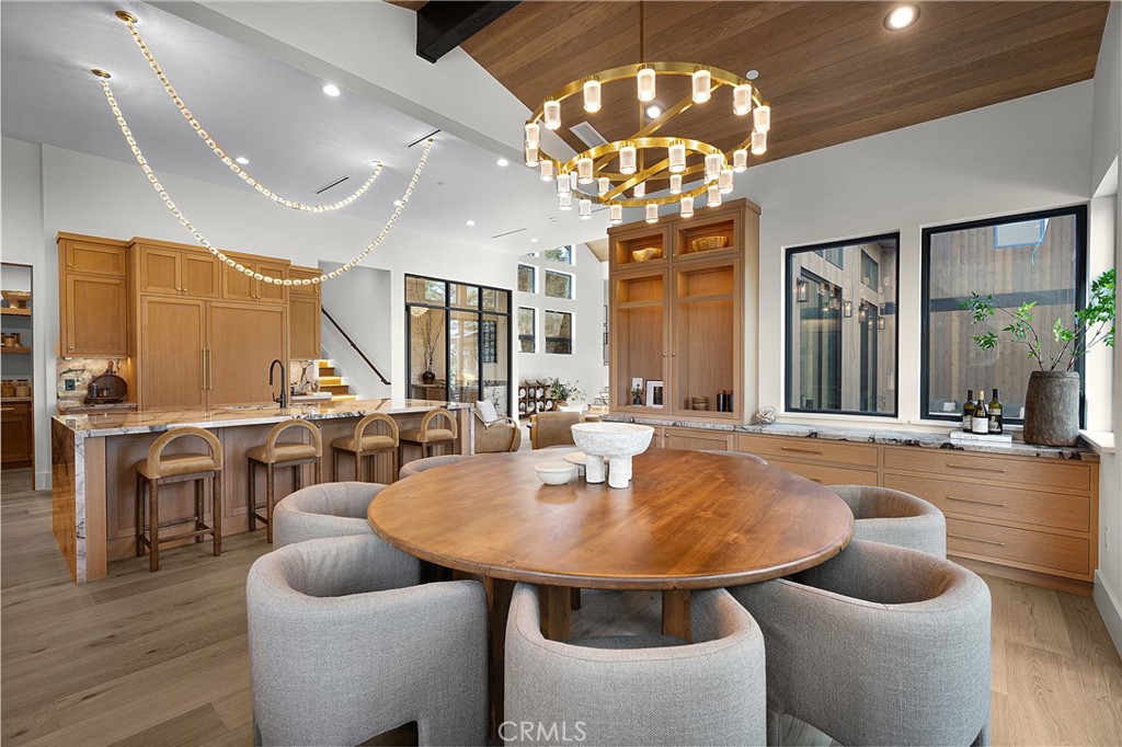 9348 Nine Bark Road Truckee, CA 96161 - Photo 36 of 58 a dining room with wooden floor a chandelier a wooden table and chairs