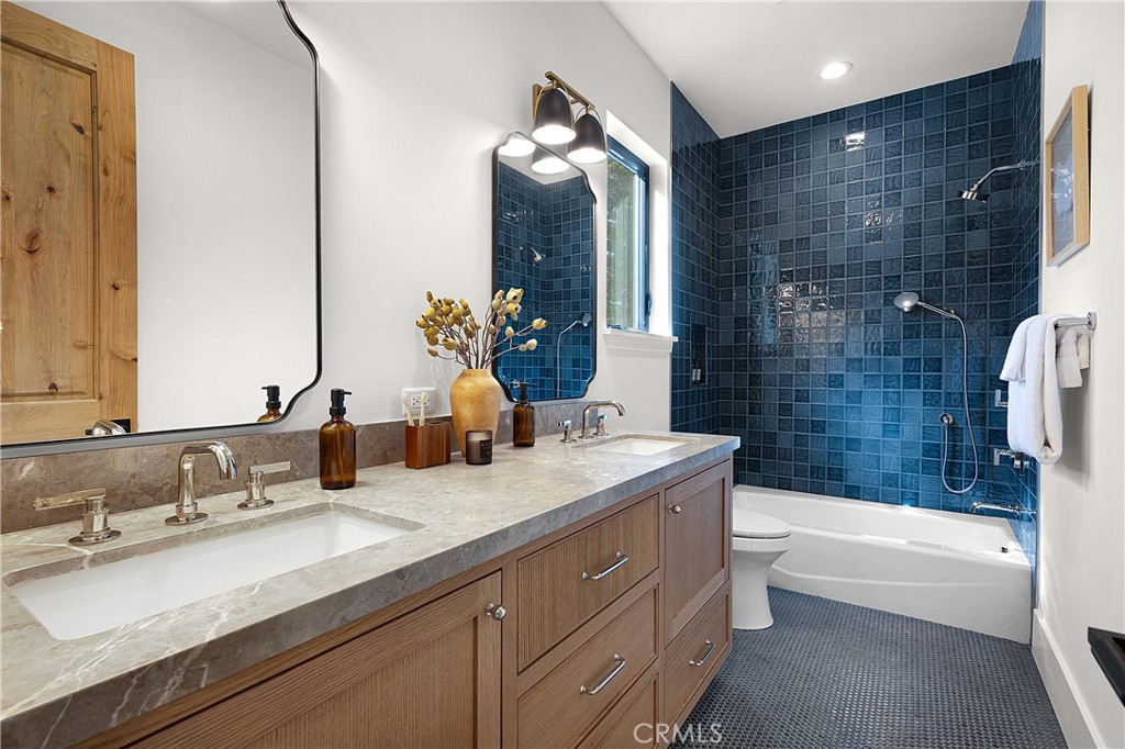 9348 Nine Bark Road Truckee, CA 96161 - Photo 42 of 58 a bathroom with a granite countertop sink mirror and a bathtub