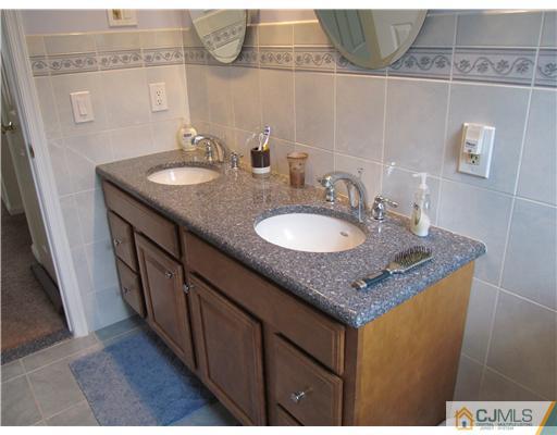 1 Timber Road East Brunswick, NJ 08816 - Photo 15 of 22 a bathroom with a granite countertop sink and a mirror