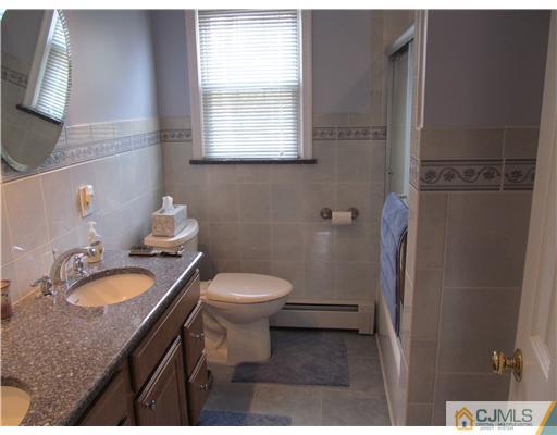1 Timber Road East Brunswick, NJ 08816 - Photo 16 of 22 a bathroom with a granite countertop toilet a sink and a mirror