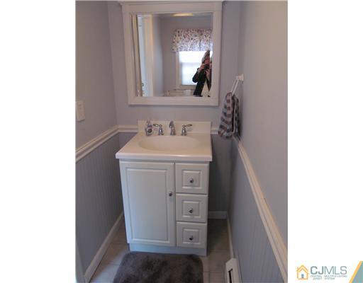 1 Timber Road East Brunswick, NJ 08816 - Photo 17 of 22 a bathroom with a sink and a mirror