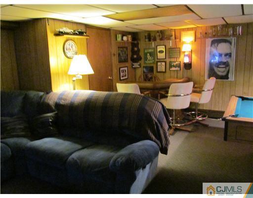 1 Timber Road East Brunswick, NJ 08816 - Photo 19 of 22 a living room with a couch and a potted plant