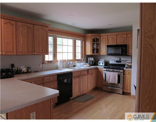 1 Timber Road East Brunswick, NJ 08816 - Photo 7 of 22 a kitchen with stainless steel appliances granite countertop a stove a sink dishwasher and a microwave oven with cabinets
