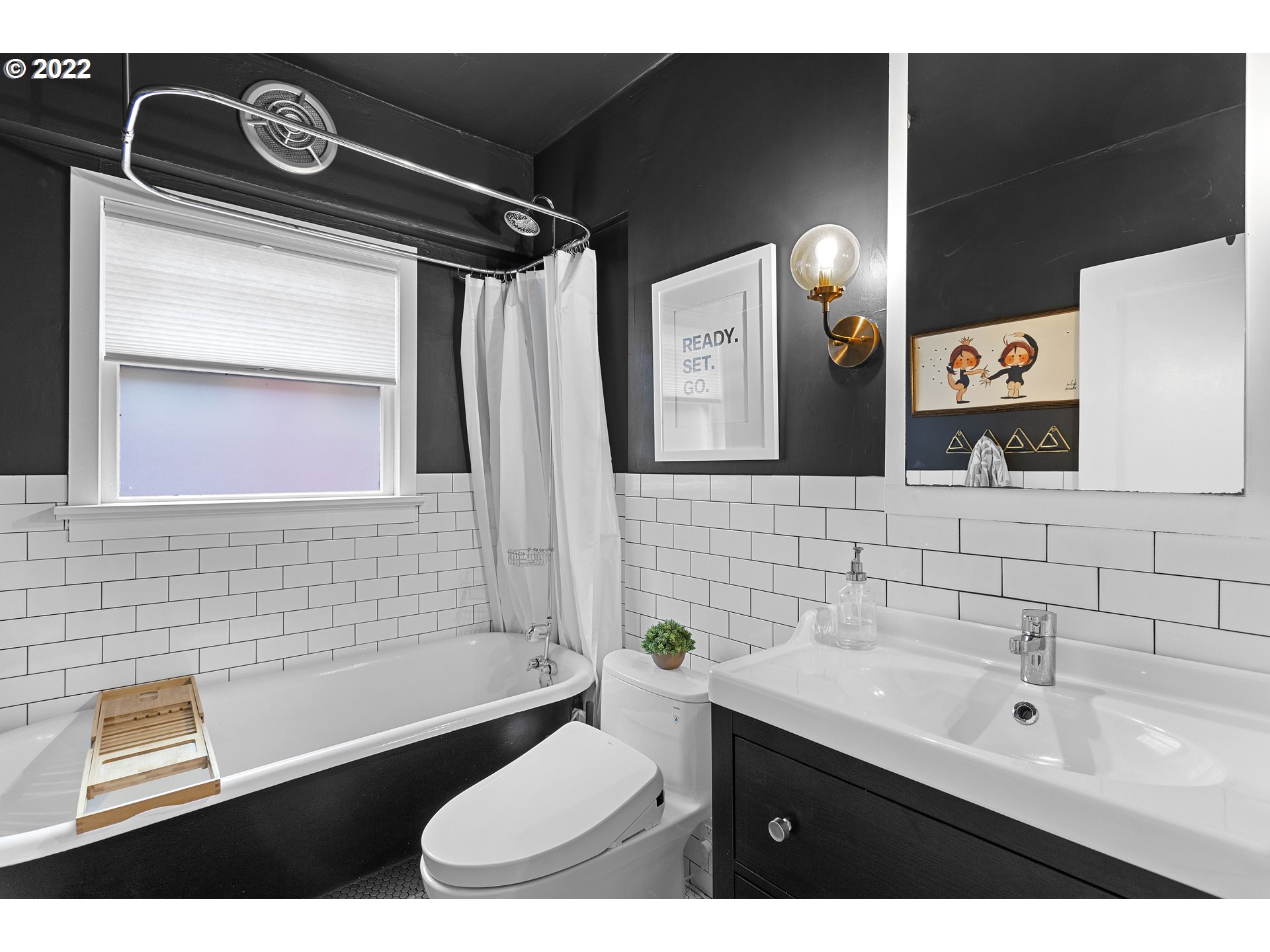 6429 North Commercial Avenue Portland, OR 97217 - Photo 11 of 32 a bathroom with a toilet sink and mirror