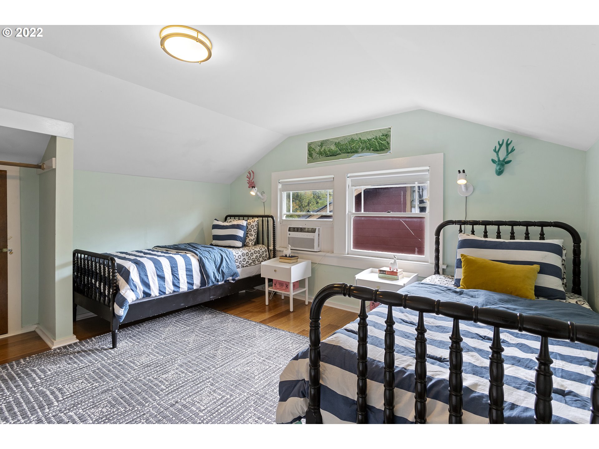6429 North Commercial Avenue Portland, OR 97217 - Photo 21 of 32 a bedroom with furniture and a wooden floor