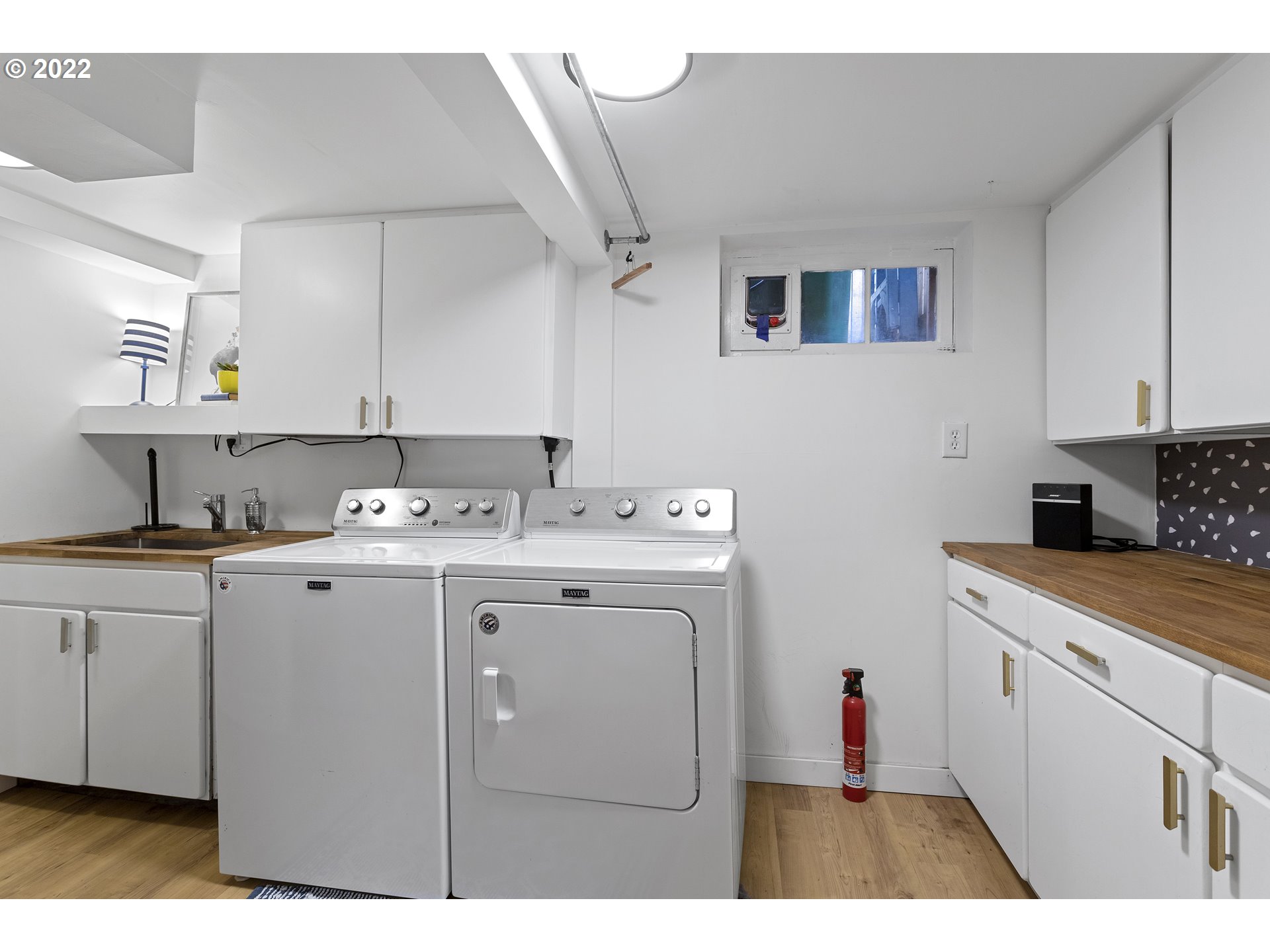 6429 North Commercial Avenue Portland, OR 97217 - Photo 29 of 32 a utility room with cabinets washer and dryer