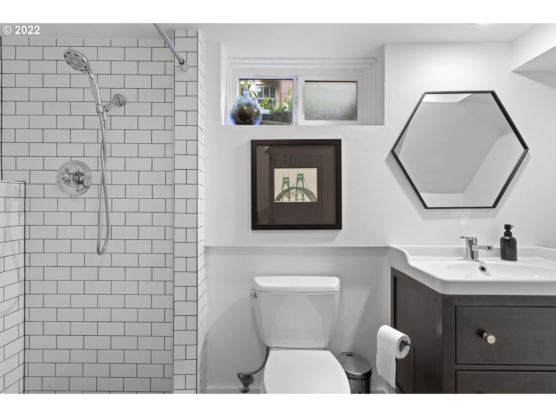 6429 North Commercial Avenue Portland, OR 97217 - Photo 30 of 32 a bathroom with a toilet sink and mirror