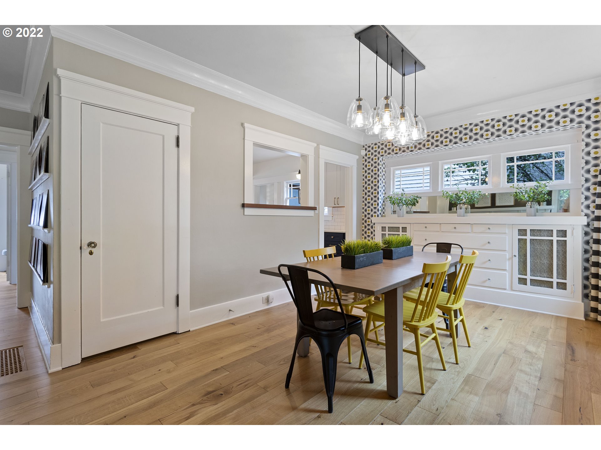 6429 North Commercial Avenue Portland, OR 97217 - Photo 5 of 32 a view of a dining room with furniture a chandelier and wooden floor