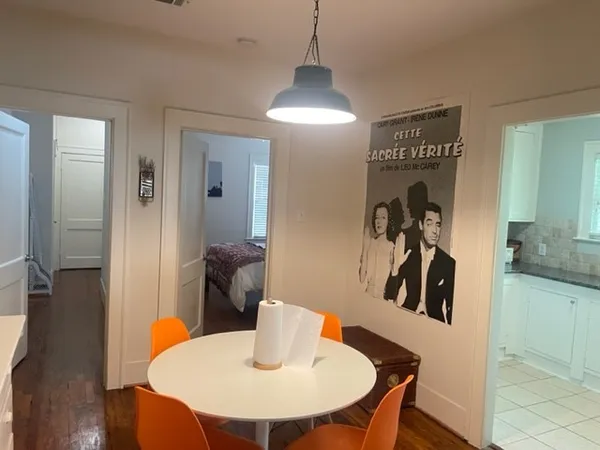 a dining room with furniture and wooden floor