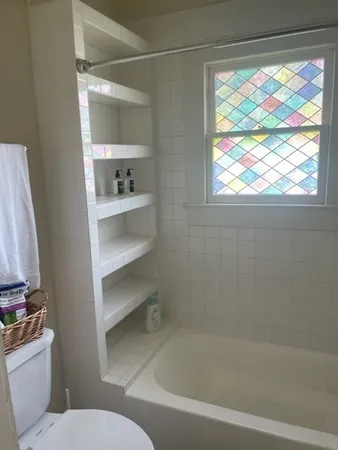 a bathroom with a bathtub and a toilet