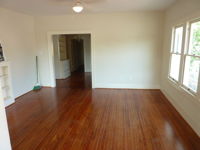4105 McKinney Street, Unit B Houston, TX 77023 - Photo 5 of 25 an empty room with wooden floor and windows