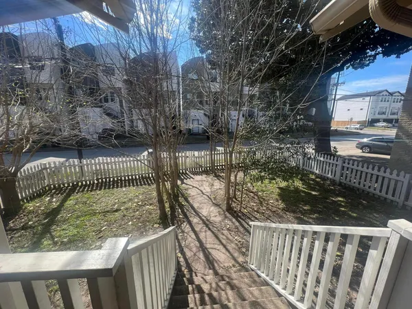 a view of balcony with wooden floor