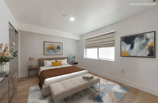 a bedroom with a bed and a painting on the wall