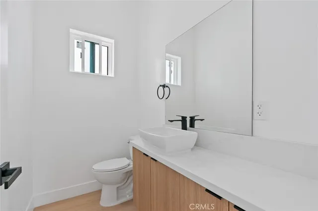 a bathroom with a sink a toilet and vanity