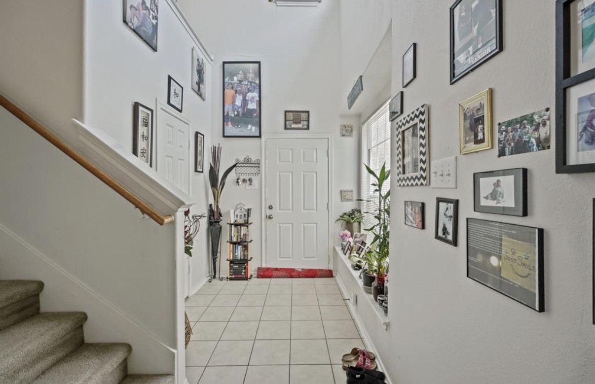 13134 Peppergate Lane Houston, TX 77044 - Photo 5 of 23 a view of an entryway with paintings on the wall